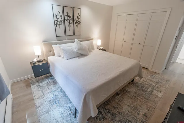 a large bed sitting in a bedroom next to a cabinet