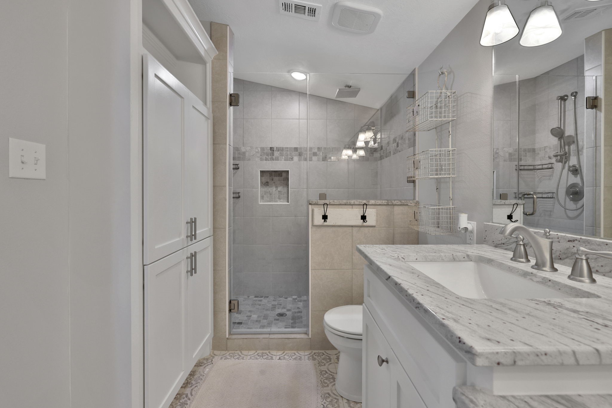20 Ridgeway Drive Coldspring, TX 77331 - Photo 13 of 40 Primary bathroom features a tiled shower, vanity, and built in shelves.