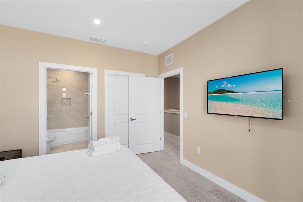 3061 Rockefeller Way Kissimmee, FL 34747 - Photo 19 of 38 a large bedroom with bed and glass door