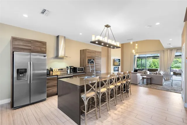 a large kitchen with lots of counter space a sink appliances and dining table