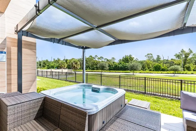 a living room with furniture and large windows
