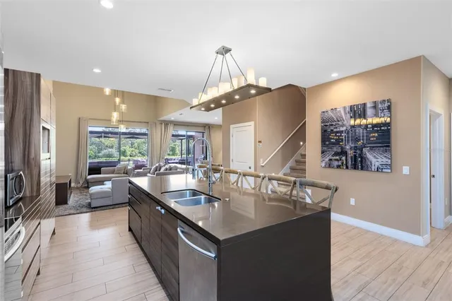 a kitchen with counter top space a sink appliances and cabinets