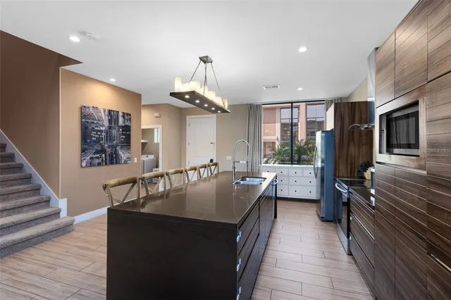 a kitchen with counter top space a sink appliances and cabinets
