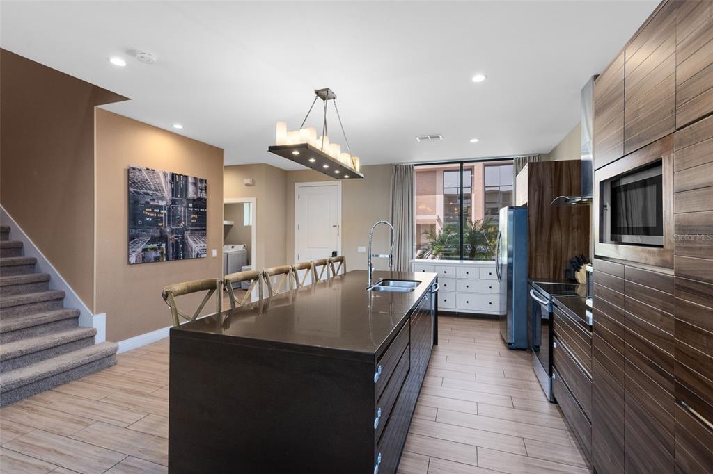 3061 Rockefeller Way Kissimmee, FL 34747 - Photo 4 of 38 a kitchen with counter top space a sink appliances and cabinets