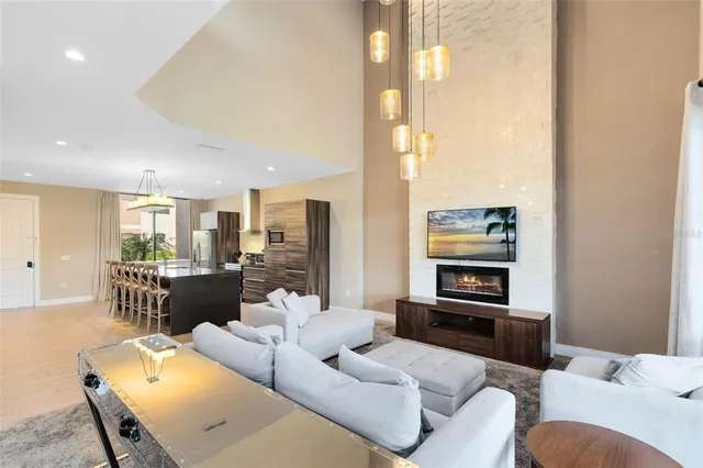 a living room with furniture a large window and a flat screen tv