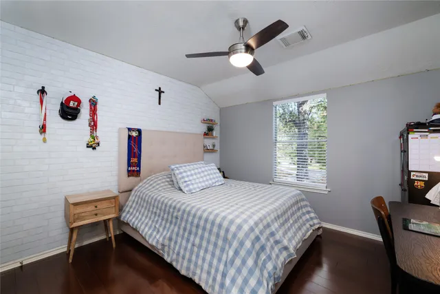 a bedroom with a bed and a chair