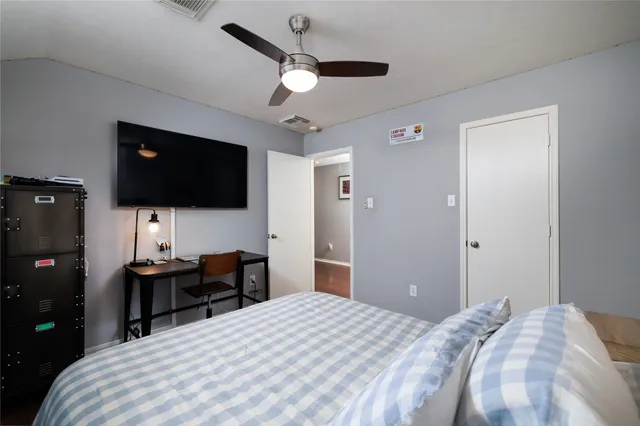 a bedroom with a bed and a flat screen tv