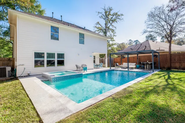 a view of a house with swimming pool in front of it