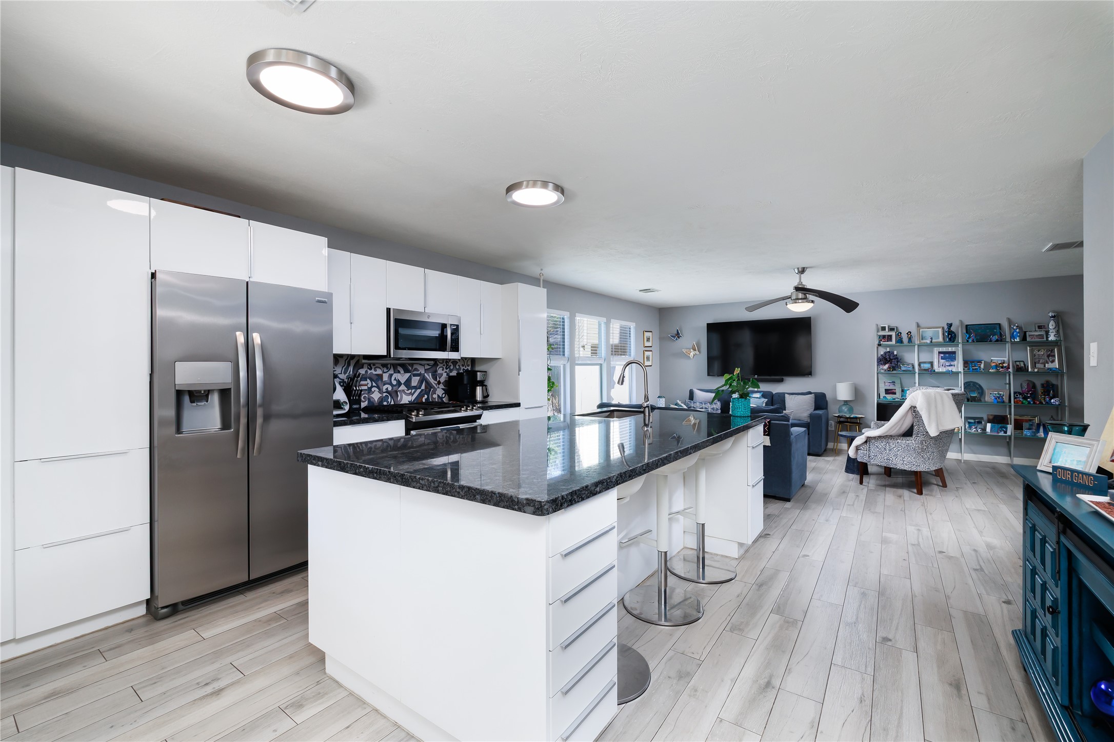 143 South Vesper Bend Circle Spring, TX 77382 - Photo 8 of 31 a kitchen with stainless steel appliances granite countertop a refrigerator a sink dishwasher a stove and a microwave oven on the wooden floor