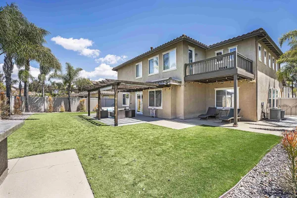 a view of a house with a yard porch and sitting area