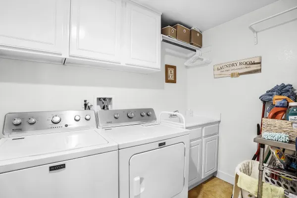 a kitchen with stainless steel appliances kitchen island granite countertop a sink stove and refrigerator