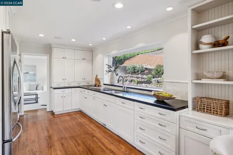 a living room with furniture a fireplace and a floor to ceiling window