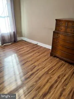 a view of wooden floor and windows in a room