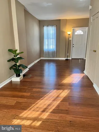 a view of a room with wooden floor and staircase
