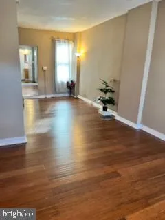 a view of a room with wooden floor and chair