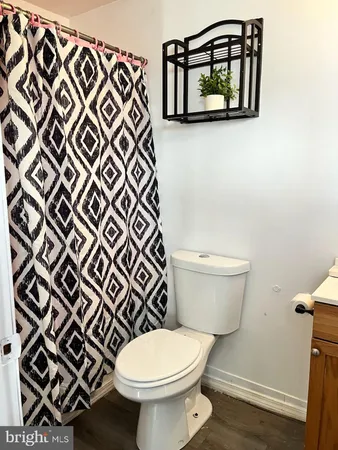 a bathroom with a toilet and a mirror