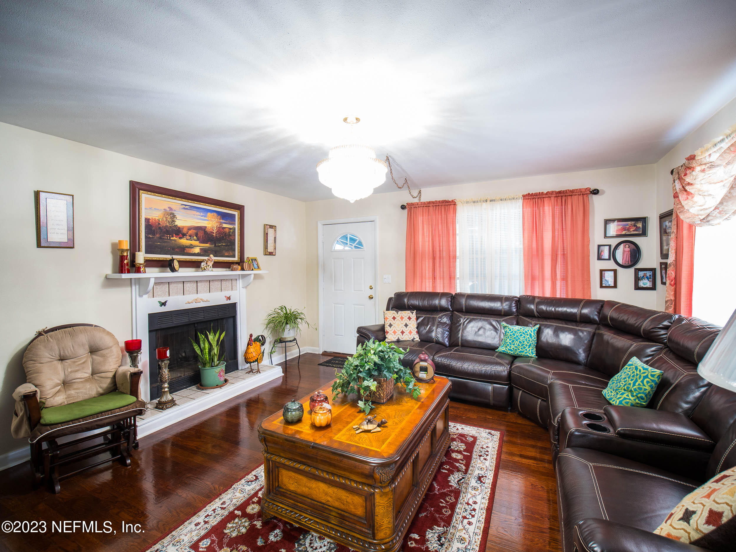 3145 Rogero Road Jacksonville, FL 32277 - Photo 5 of 21 a living room with furniture a fireplace and a flat screen tv
