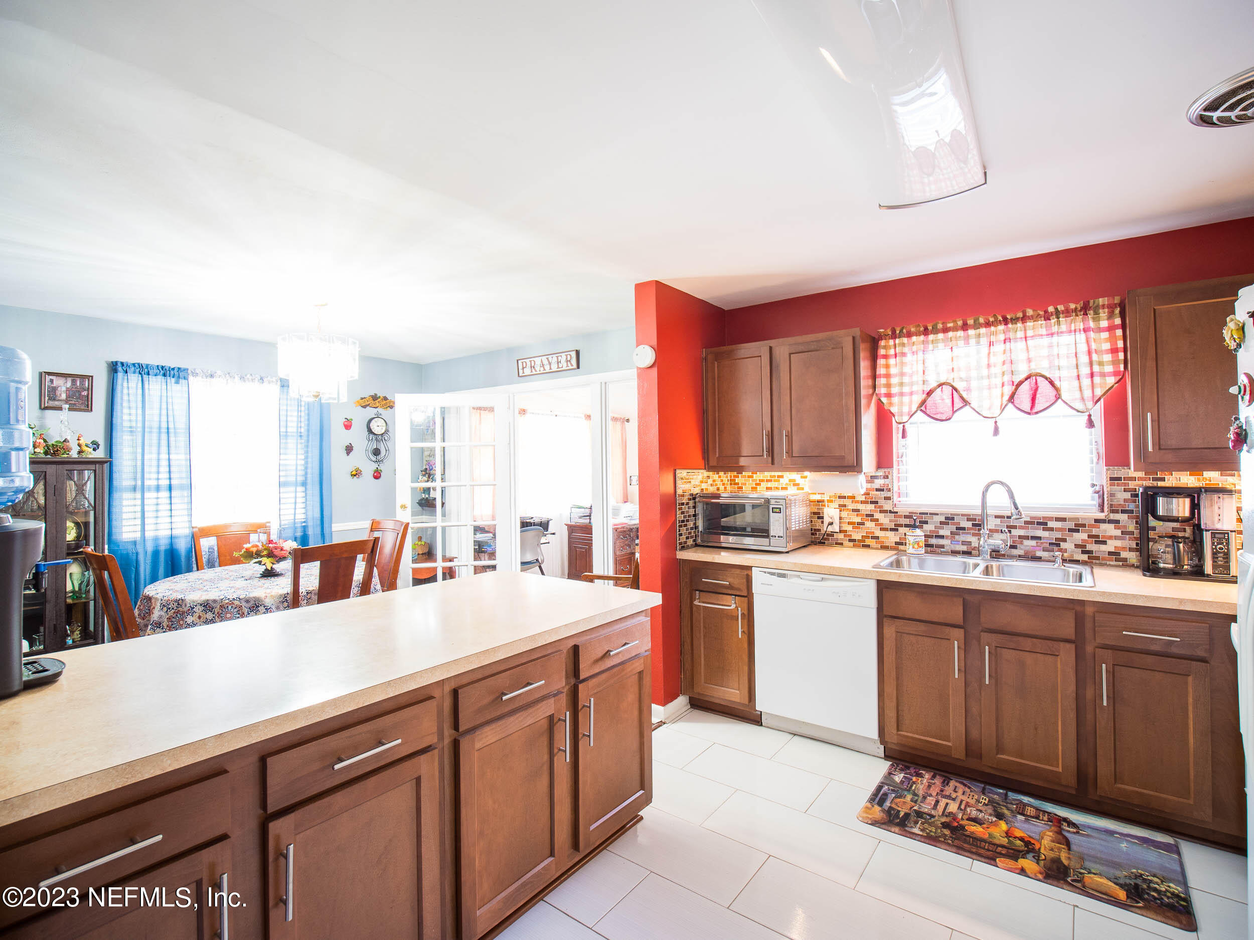 3145 Rogero Road Jacksonville, FL 32277 - Photo 8 of 21 a kitchen with a sink stove and cabinets