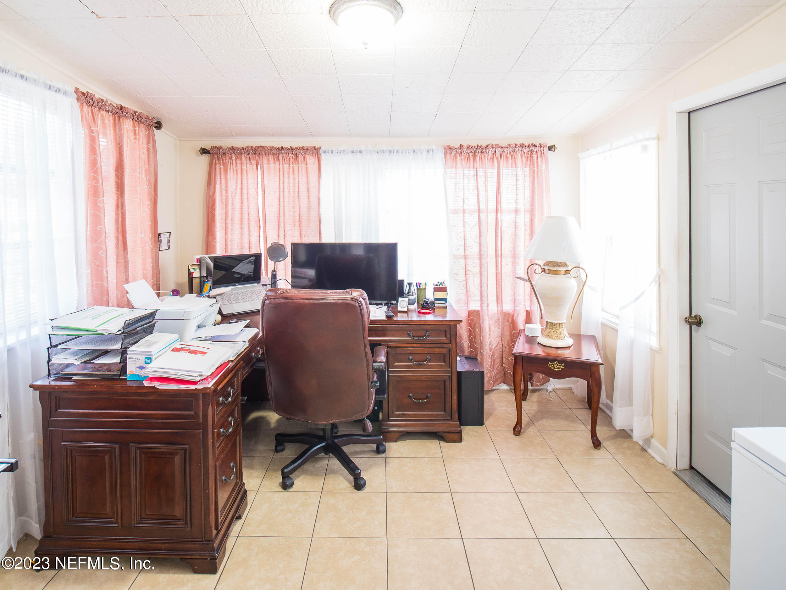 3145 Rogero Road Jacksonville, FL 32277 - Photo 10 of 21 a view of a workspace with furniture and a window