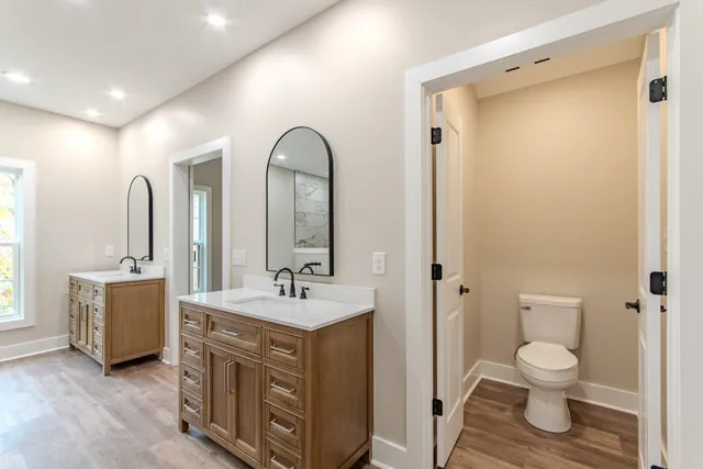 a view of bathroom with a toilet a sink and a mirror