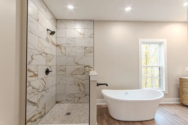 a bathroom with a bathtub and shower