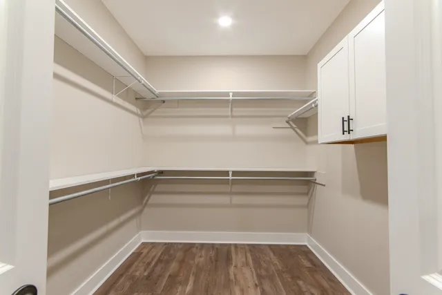 a view of walk in closet with empty racks