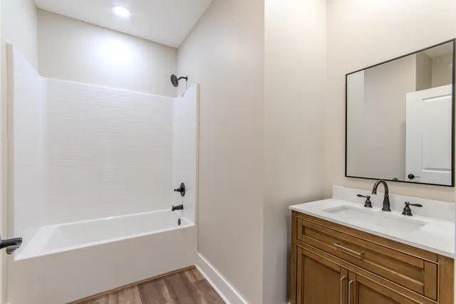 a bathroom with a sink a mirror and a bathtub