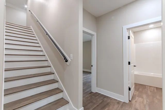 a view of entryway with wooden floor and stairs