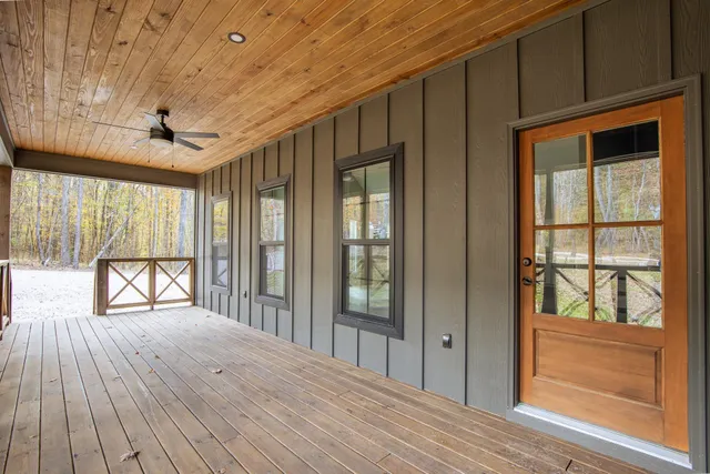 a view of outdoor space with wooden floor and windows