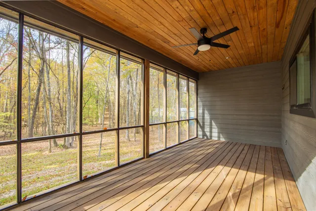 a view of wooden floor in a hall with a window