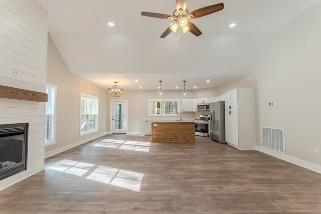 a view of kitchen with sink microwave and refrigerator