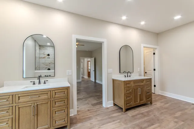 a spacious bathroom with a double vanity sink double and mirror