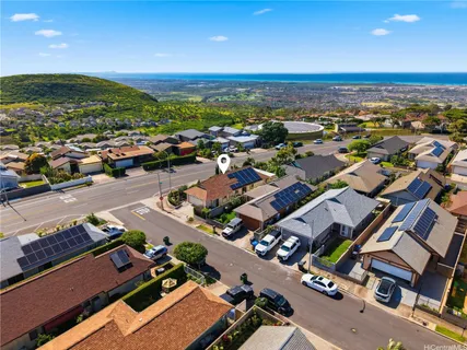 an aerial view of a city with lots of residential buildings and mountain view in back