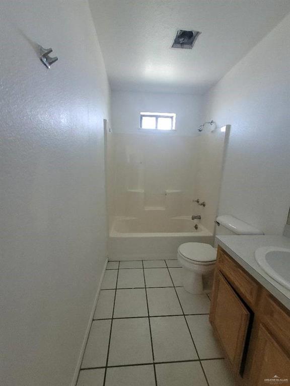 1612 Orange Avenue, Unit 13 Weslaco, TX 78596 - Photo 12 of 12 Full bathroom featuring vanity, tile patterned floors, shower / washtub combination, and toilet
