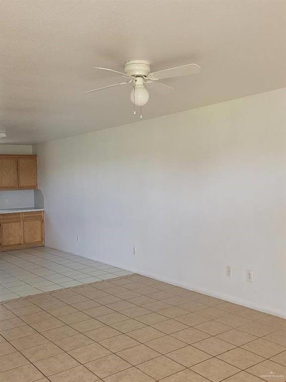 1612 Orange Avenue, Unit 13 Weslaco, TX 78596 - Photo 5 of 12 Unfurnished room with light tile patterned floors and ceiling fan