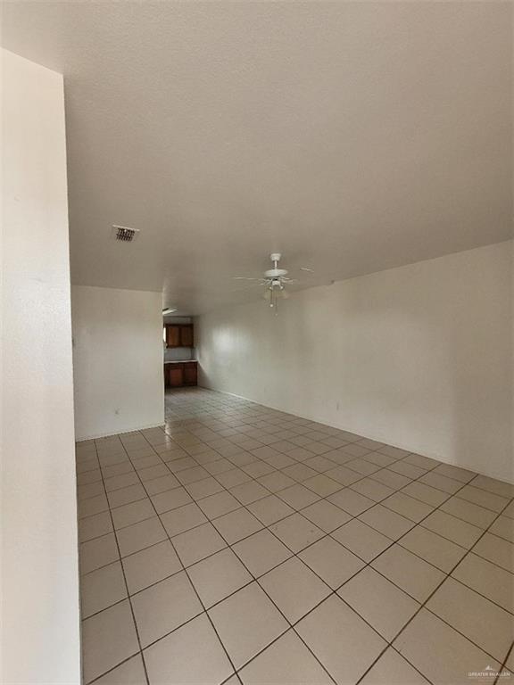 1612 Orange Avenue, Unit 13 Weslaco, TX 78596 - Photo 6 of 12 Spare room with ceiling fan and light tile patterned flooring