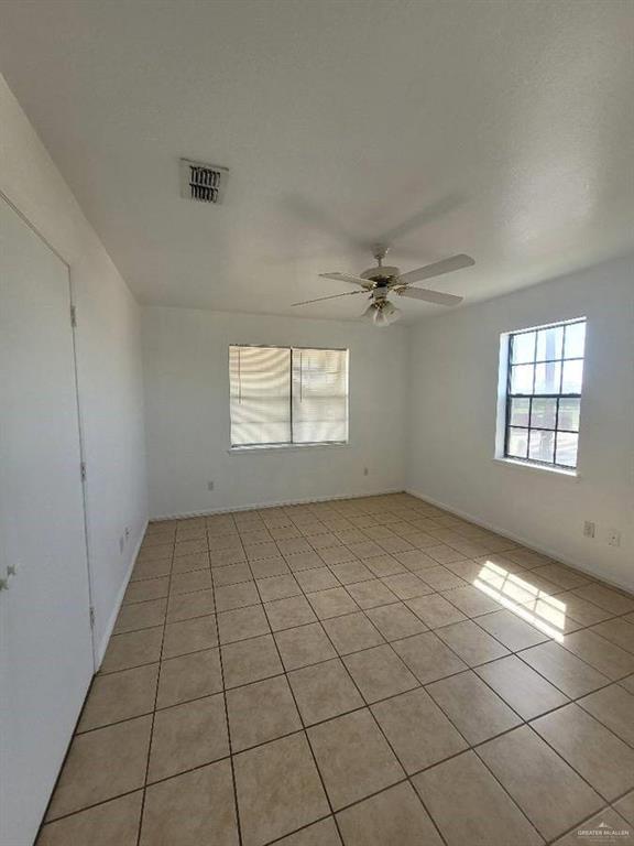1612 Orange Avenue, Unit 13 Weslaco, TX 78596 - Photo 10 of 12 Empty room with light tile patterned floors and ceiling fan