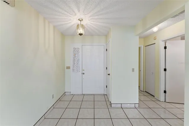 a view of a livingroom with an empty space and a chandelier