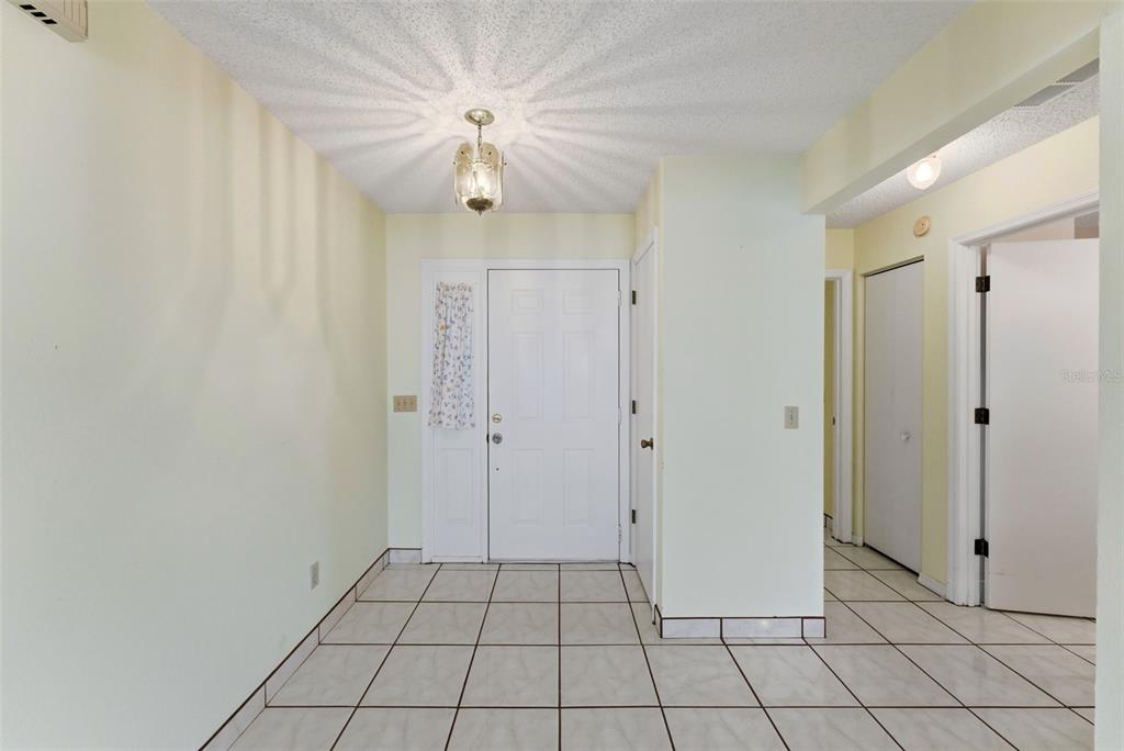 4141 Southwest Sailfish Road Dunnellon, FL 34431 - Photo 11 of 63 a view of an empty room with window and chandelier fan