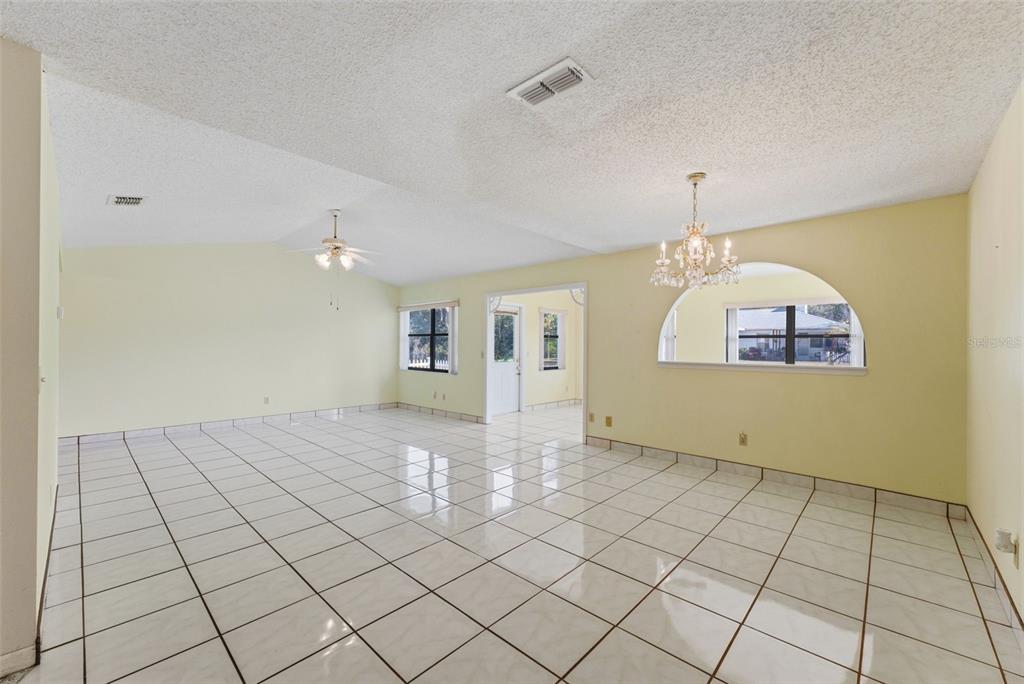 4141 Southwest Sailfish Road Dunnellon, FL 34431 - Photo 15 of 63 a view of a livingroom with an empty space and a chandelier