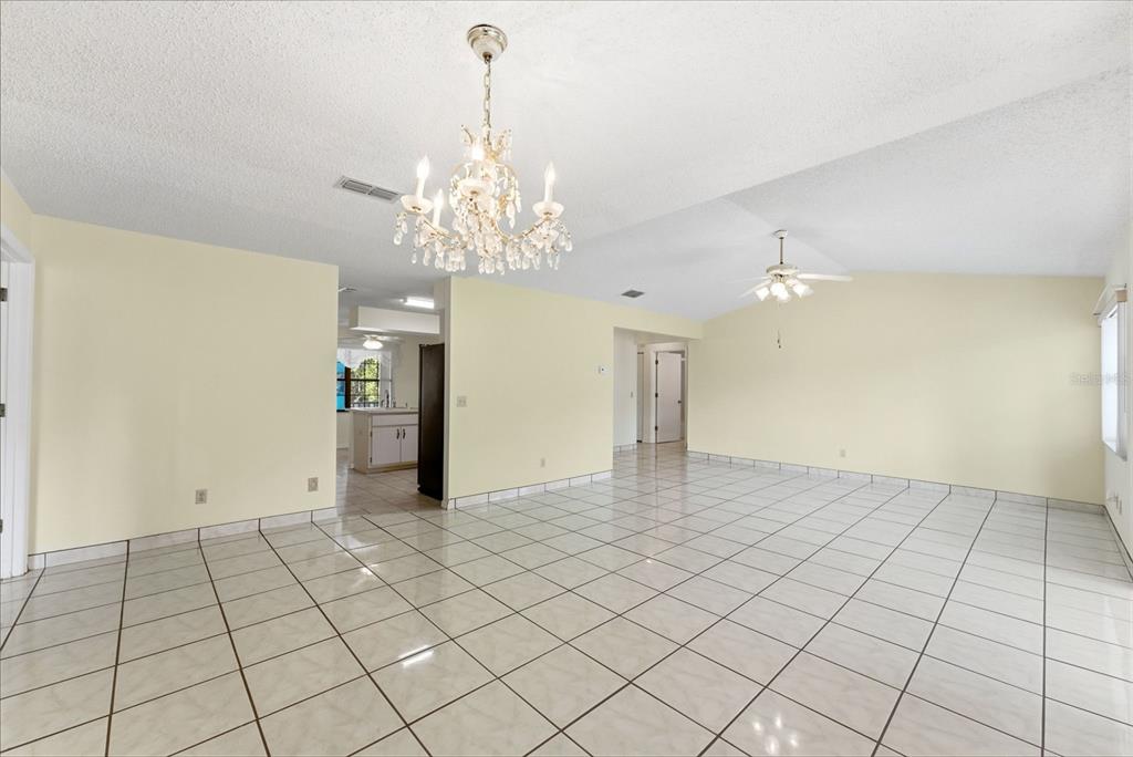 4141 Southwest Sailfish Road Dunnellon, FL 34431 - Photo 17 of 63 a view of a livingroom with a chandelier fan and windows