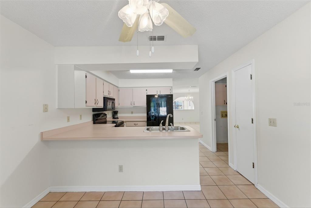 4141 Southwest Sailfish Road Dunnellon, FL 34431 - Photo 21 of 63 a view of a kitchen with kitchen island a counter top space appliances and cabinets