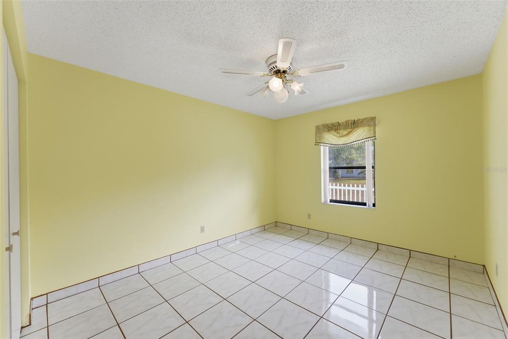 4141 Southwest Sailfish Road Dunnellon, FL 34431 - Photo 31 of 63 a view of an empty room with a window and chandelier fan