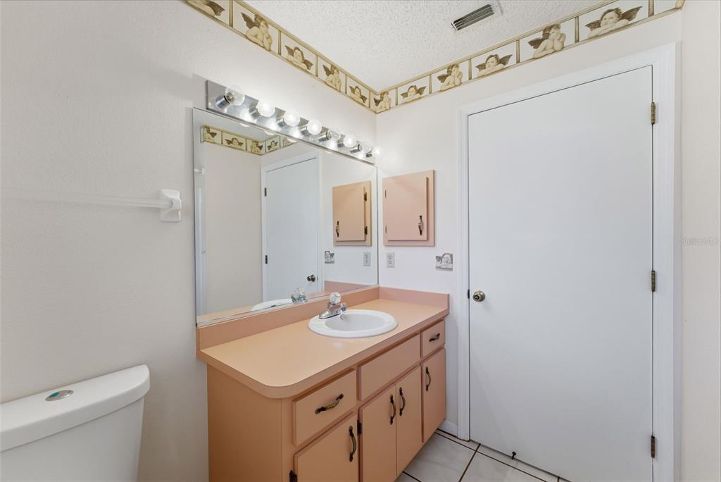 4141 Southwest Sailfish Road Dunnellon, FL 34431 - Photo 35 of 63 a bathroom with a sink vanity and a mirror