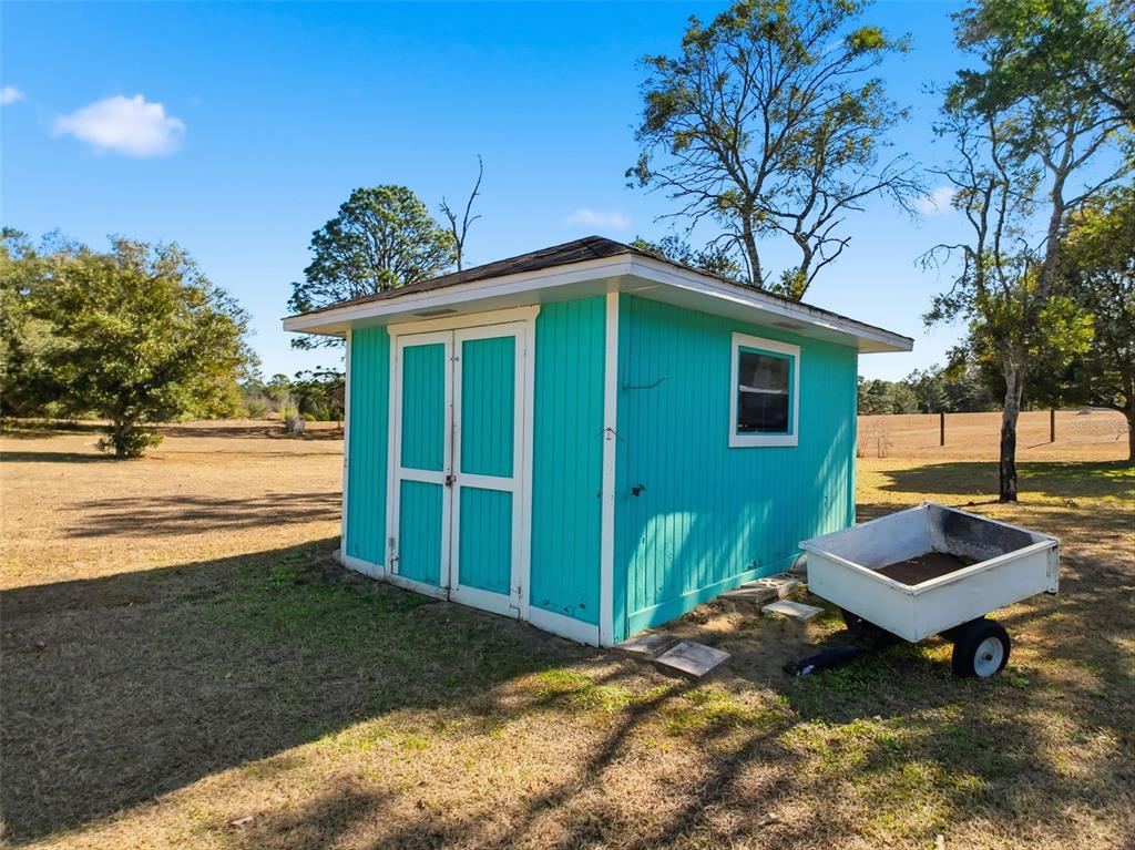 4141 Southwest Sailfish Road Dunnellon, FL 34431 - Photo 58 of 63 a backyard of a house with table and chairs
