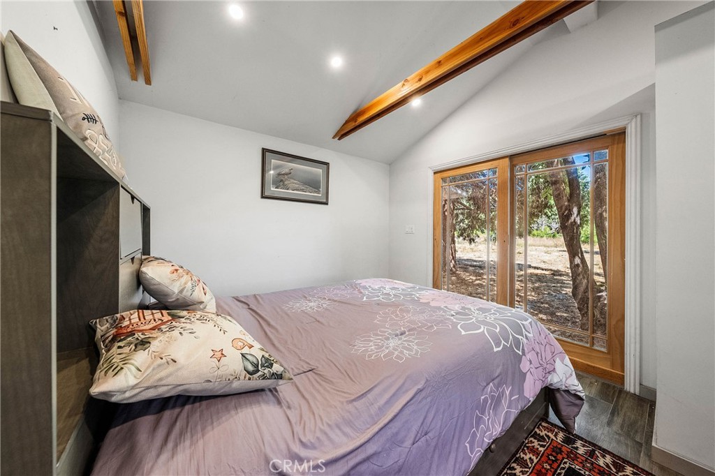 1980 Big Valley Road Lakeport, CA 95453 - Photo 39 of 56 a bedroom with a bed and wooden floor