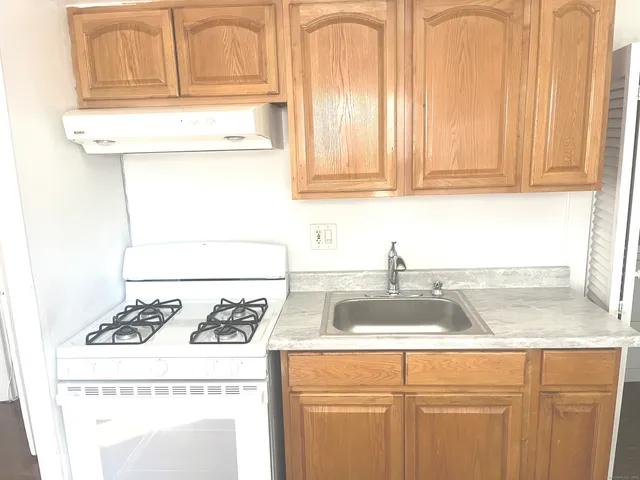 a kitchen with granite countertop cabinets and sink