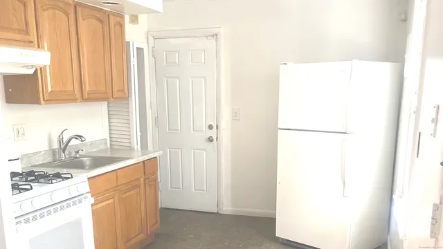 a kitchen with a sink and a refrigerator