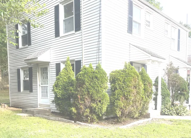 a view of a house with a yard and sitting space