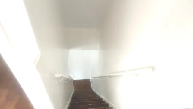 a view of a hallway with stairs